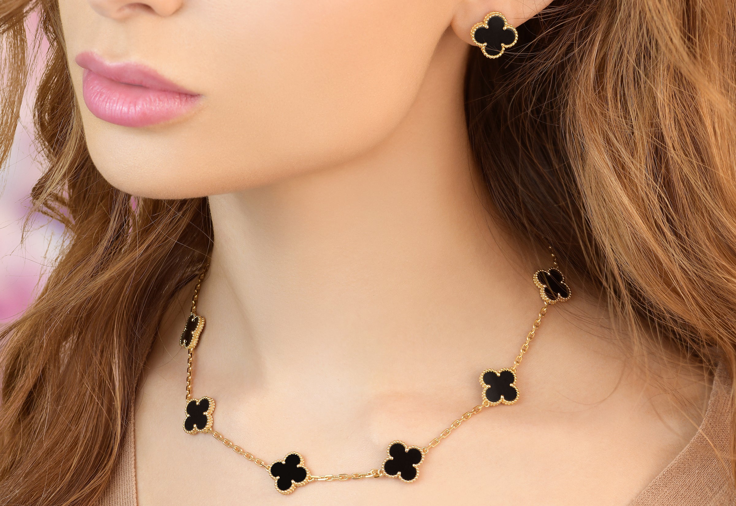 a model wearing van cleef and arpels necklace and earrings