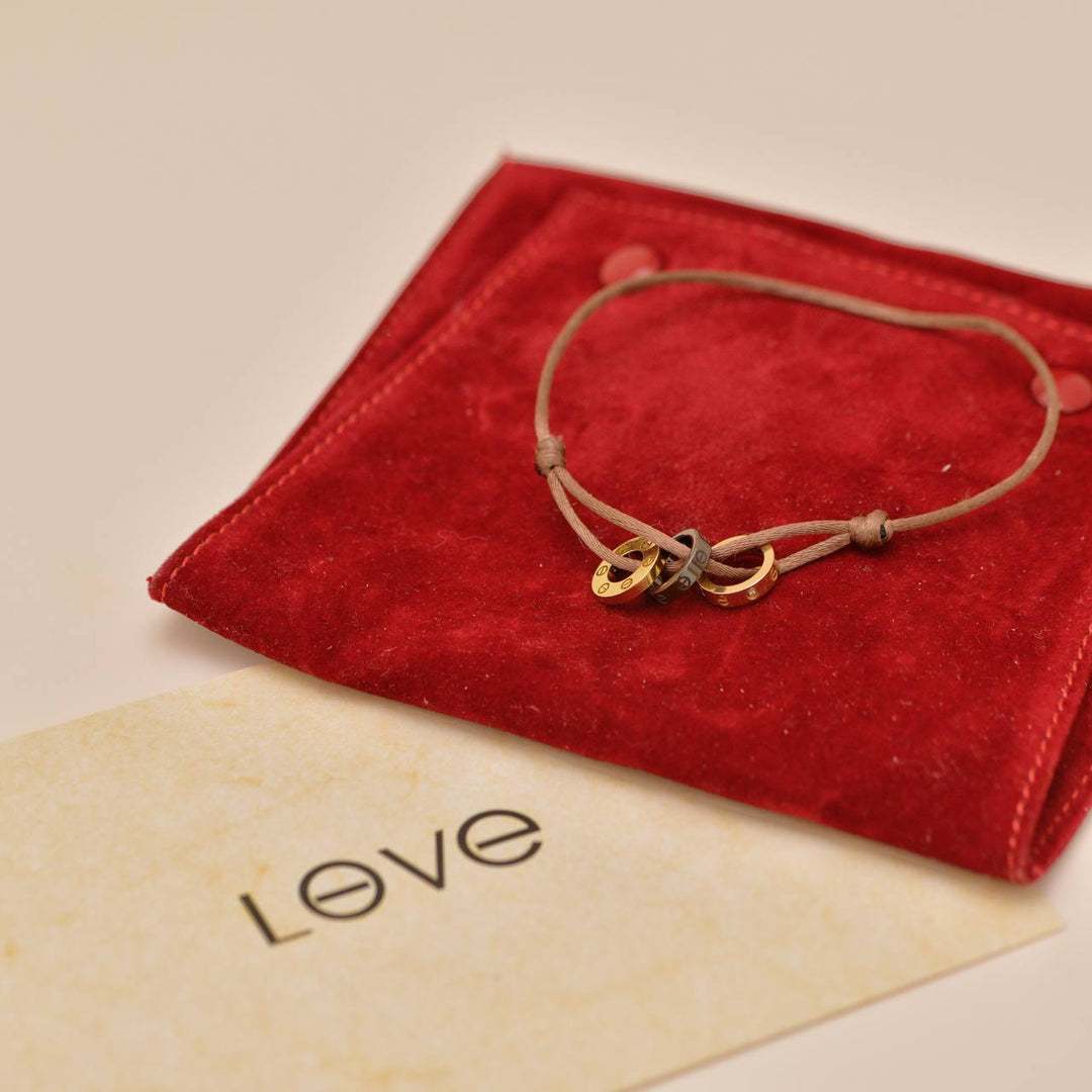 Preowned Authentic Cartier Love Cord Bracelet 4 Diamonds Sèvres Porcelain in 18K Yellow & Rose Gold