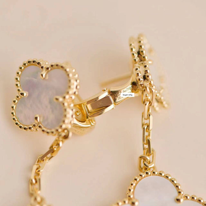 Second-hand Van Cleef & Arpels Magic Alhambra Two Motifs Mother of Pearl Yellow Gold Earrings, elegant and timeless.