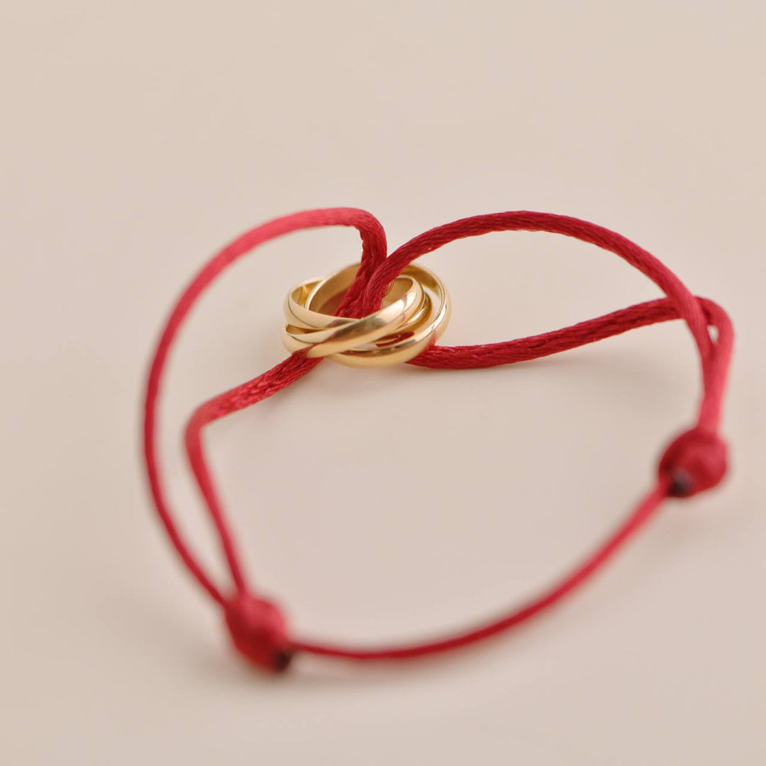 Pre-owned Cartier Trinity 18K Rose Gold Bracelet featuring a red silk cord