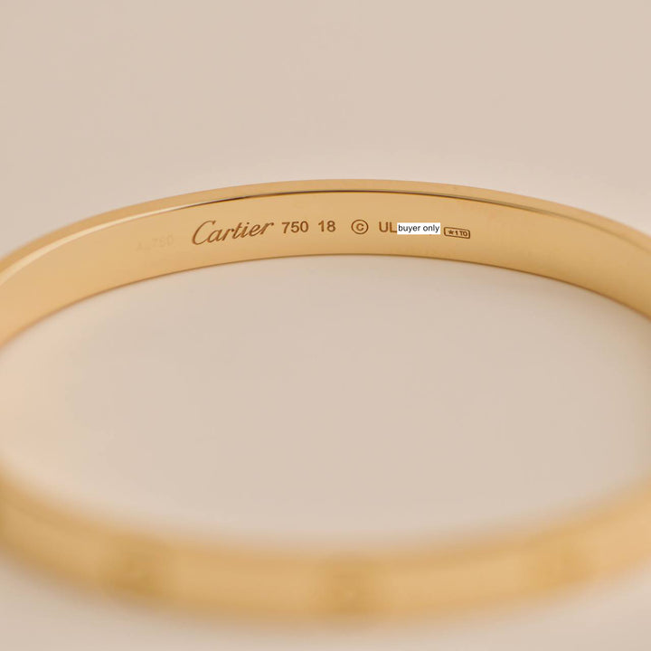 "Pre-owned Cartier Love Bracelet 18K Yellow Gold Size 18, featuring signature screw design.