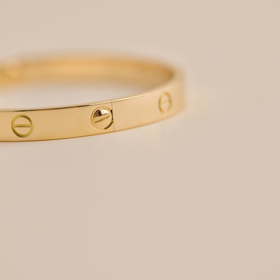 Elegant pre-owned Cartier Love Bracelet 18K Yellow Gold Size 18, timeless jewellery piece