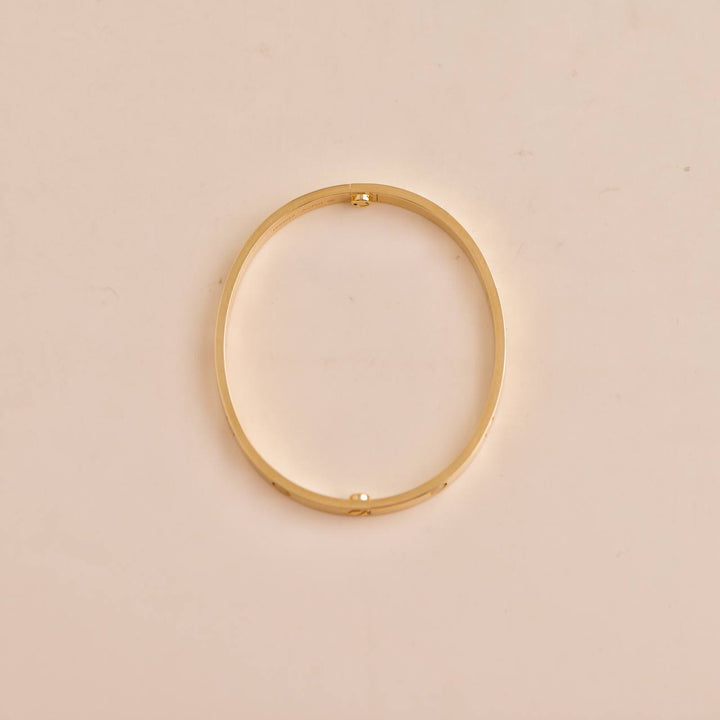 Second-hand Cartier Love Bracelet 18K Yellow Gold Size 17, symbolising enduring love.