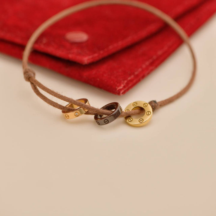 Preowned Cartier Love 18k Yellow & Rose 4 Diamond Sèvres Porcelain Brown Cord Bracelet