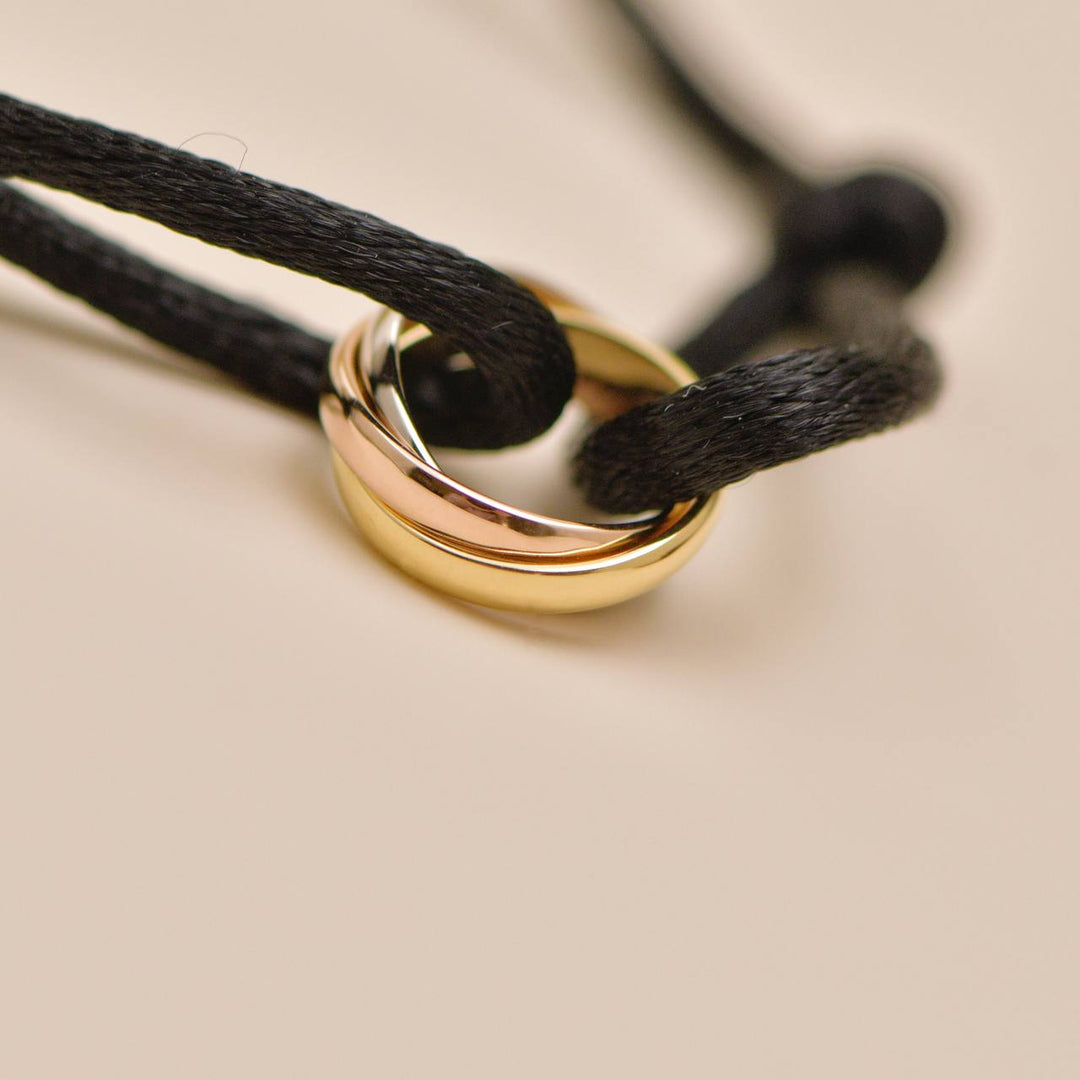 Second Hand Authentic Cartier Trinity 18K White, Rose and Yellow Gold Black Cord Bracelet