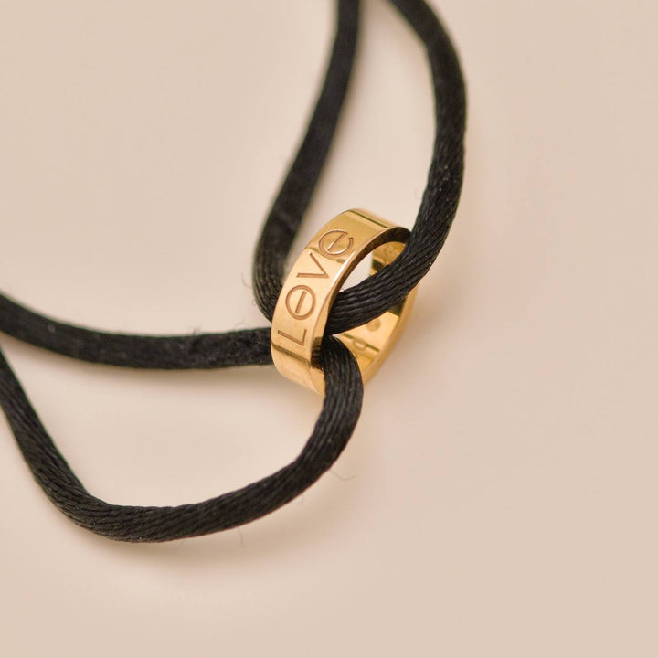 Authentic Used Cartier Love Cord bracelet in 18K rose gold with black adjustable cord