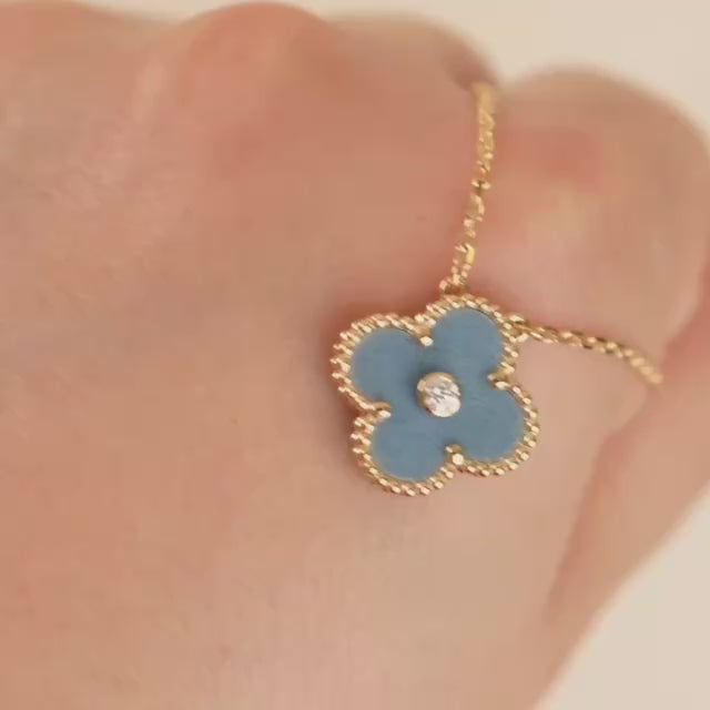 Video of Van Cleef & Arpels 2026 Holiday pendant showing blue grey porcelain and diamond details