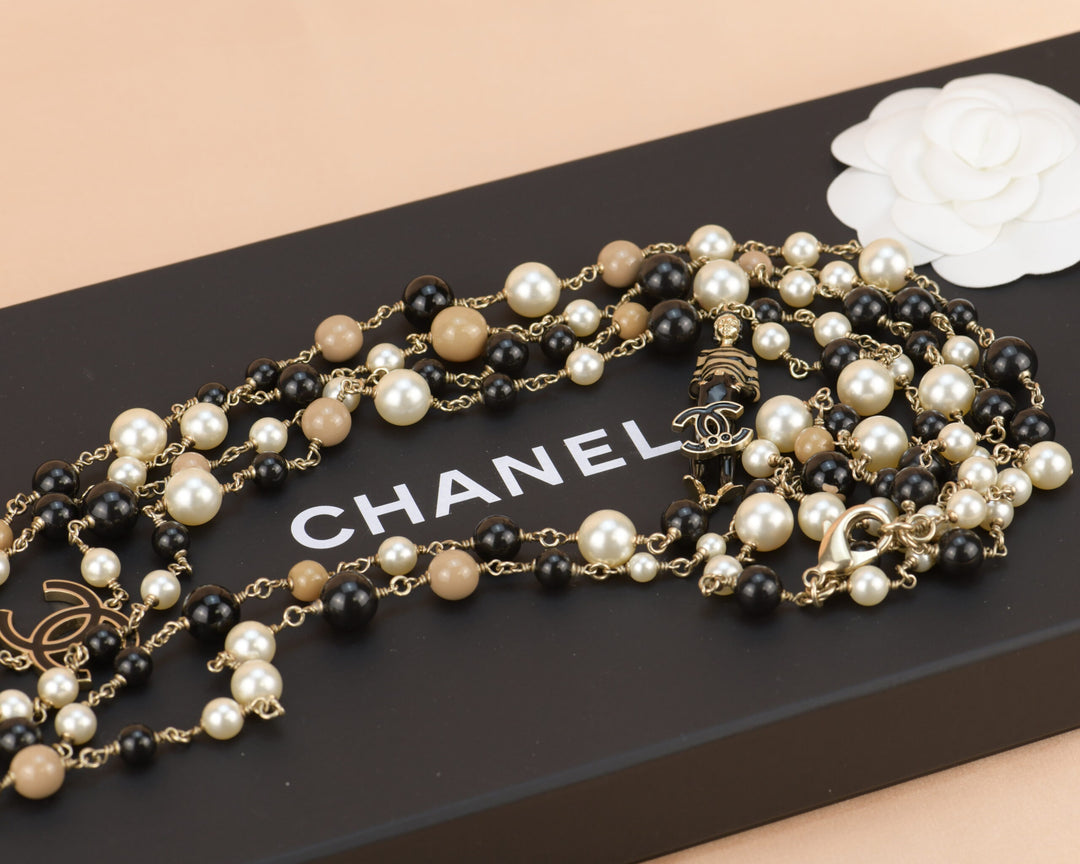 Chanel double strand necklace with faux pearl and gold tone embossed metal  beads, mid 1900s