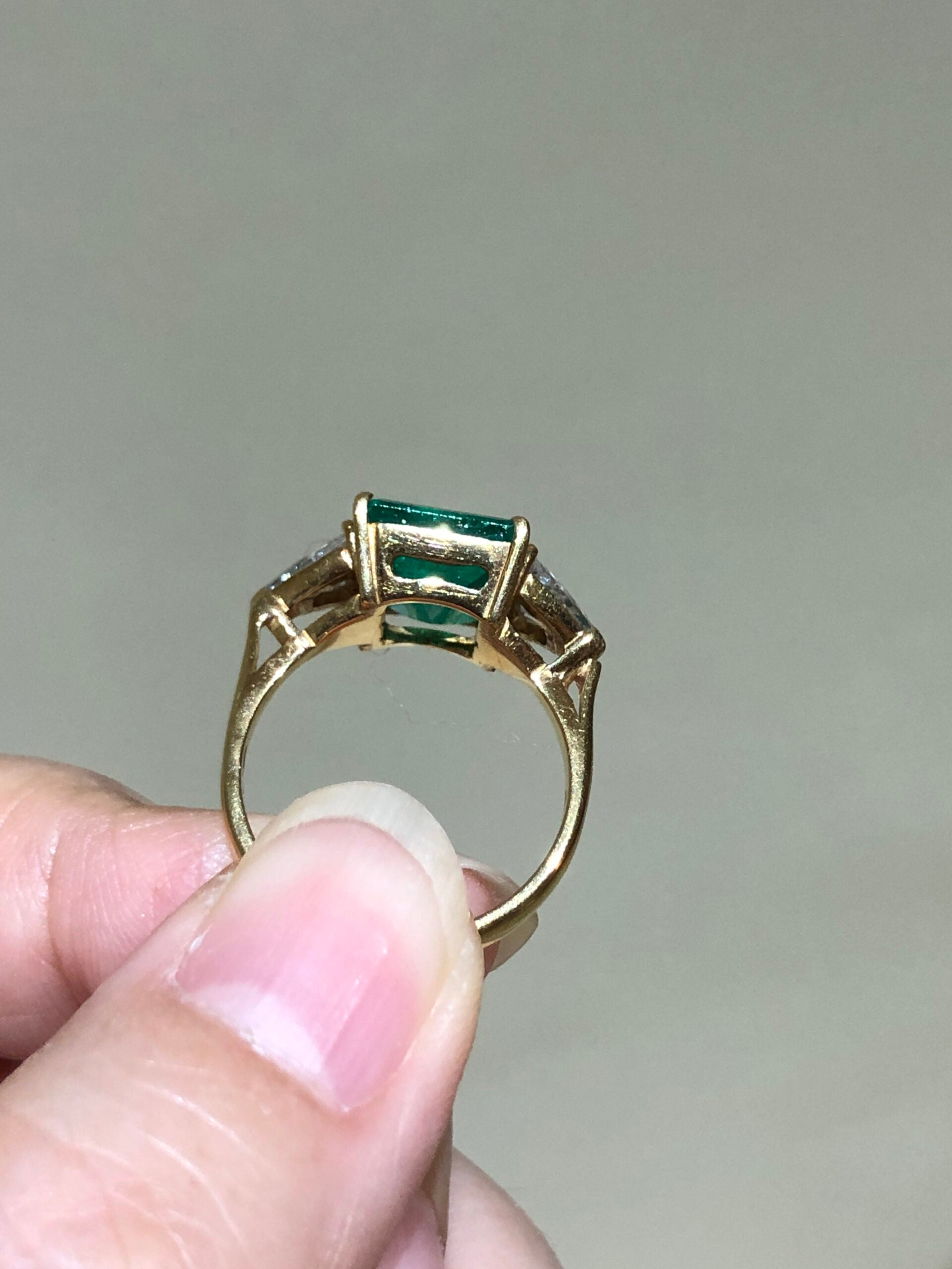 Emerald and store gold engagement ring