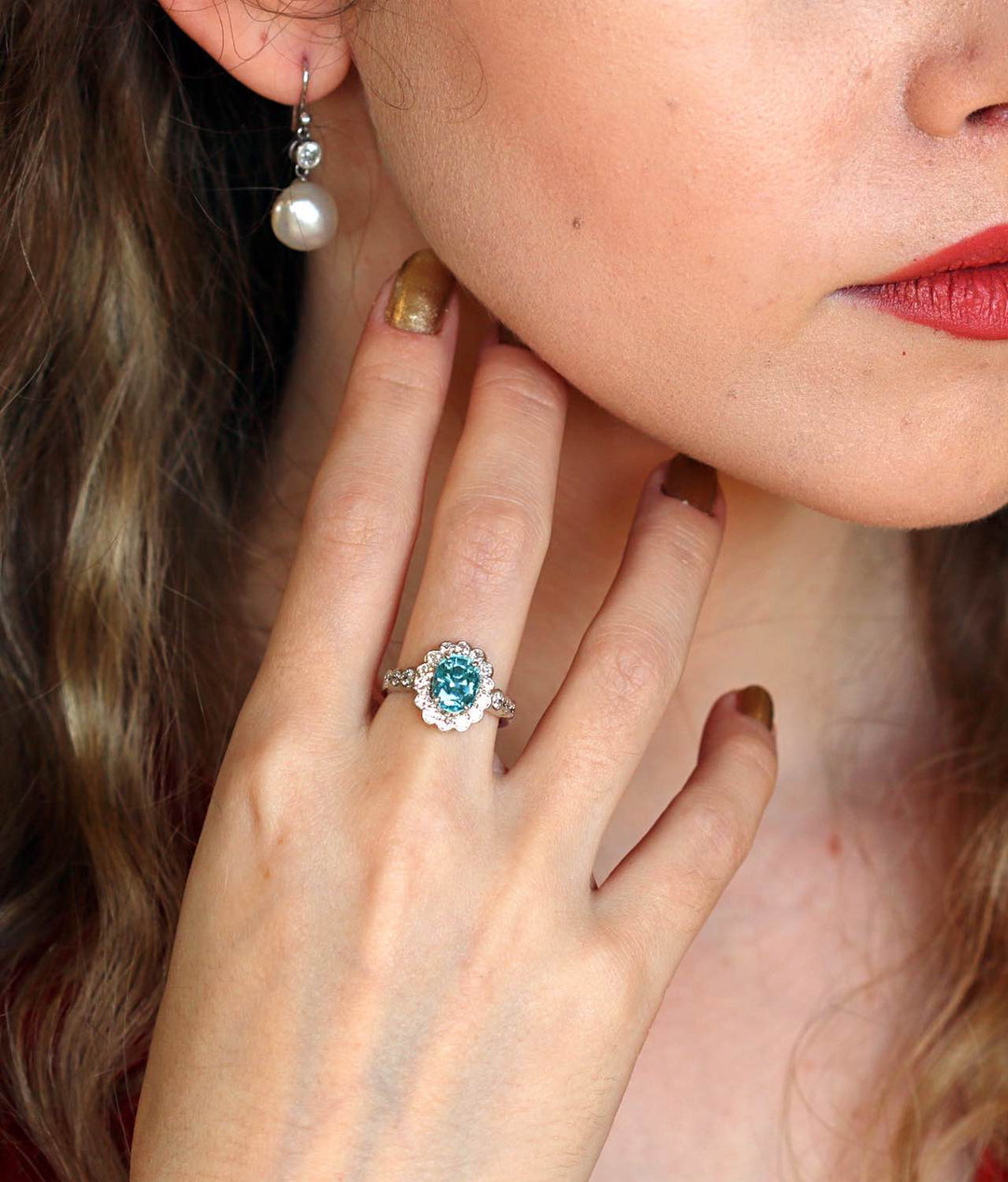 Blue zircon and diamond cluster ring on a model's hand