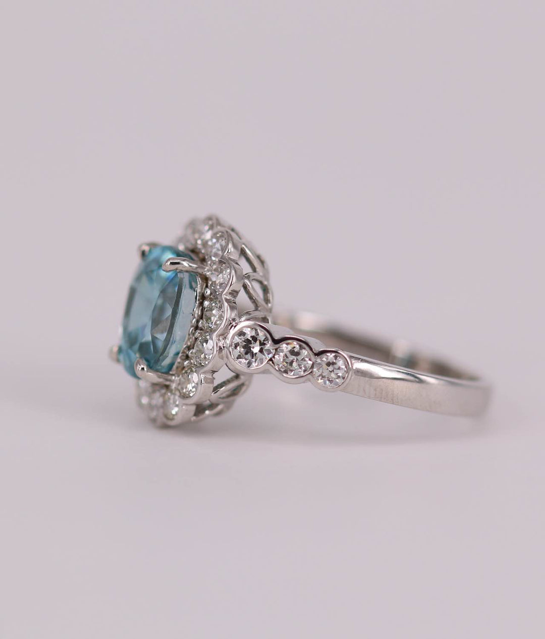 Blue zircon and diamond cluster ring side view